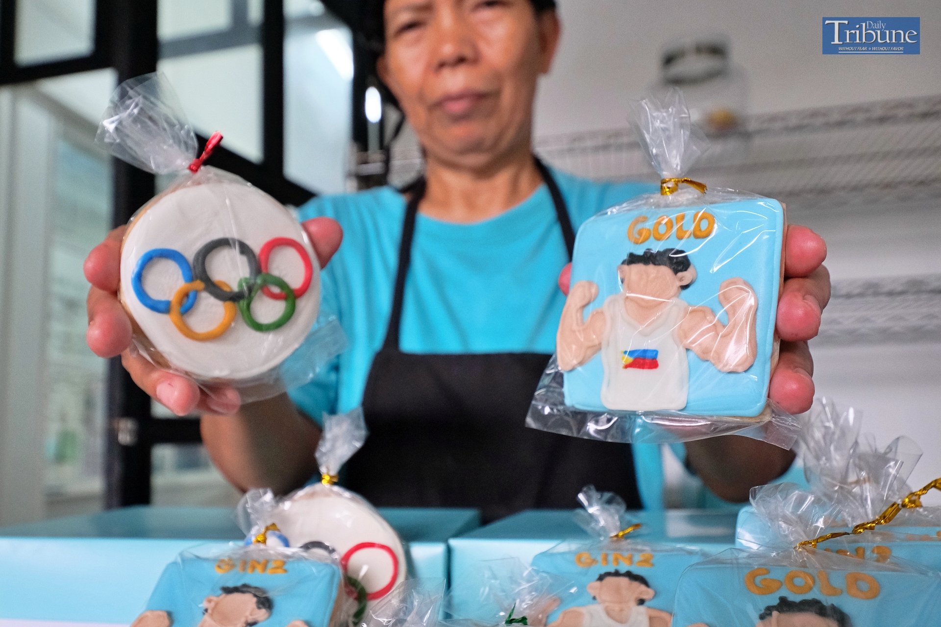 LOOK: An employee of a pastry shop in Quezon City displays various Olympic-themed cookies, including one featuring two-time gold medalist Carlos Yulo, which they are selling for P65 each on Saturday, 10 August 2024.
